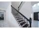 Modern staircase with black railings and white risers at 16548 Raven Rock Pl, Winter Garden, FL 34787