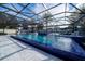 Luxury pool with covered patio, water features, and ample lounge space at 16548 Raven Rock Pl, Winter Garden, FL 34787