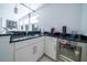 Modern wet bar with granite countertop and mini-fridge at 16548 Raven Rock Pl, Winter Garden, FL 34787