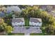 Aerial view of two townhouses with private parking and a tranquil lake setting at 17354 Blessing Dr, Clermont, FL 34714