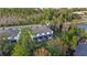 Aerial view of a townhome community nestled amongst Florida greenery, near a calm lake at 17354 Blessing Dr, Clermont, FL 34714