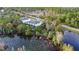 Aerial view showcasing a townhome's serene waterfront location, surrounded by lush vegetation at 17354 Blessing Dr, Clermont, FL 34714