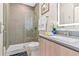 Clean bathroom with a walk-in shower and gray tile at 17354 Blessing Dr, Clermont, FL 34714