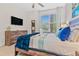Bright bedroom featuring a king-size bed and large window at 17354 Blessing Dr, Clermont, FL 34714