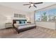 Main bedroom with large window and plush carpeting at 17354 Blessing Dr, Clermont, FL 34714