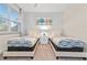 Spacious bedroom with two twin beds, plenty of natural light, and neutral decor at 17354 Blessing Dr, Clermont, FL 34714