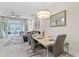 Elegant dining room with a marble table and modern chairs, offering pool views at 17354 Blessing Dr, Clermont, FL 34714
