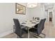 Modern dining room with marble table and four gray chairs at 17354 Blessing Dr, Clermont, FL 34714