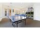 Community game room with ping pong table, arcade games, and a relaxing seating area at 17354 Blessing Dr, Clermont, FL 34714