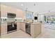 Modern kitchen with stainless steel appliances and an island with seating at 17354 Blessing Dr, Clermont, FL 34714