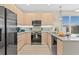 Modern kitchen featuring stainless steel appliances and light wood cabinets at 17354 Blessing Dr, Clermont, FL 34714