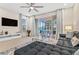 Living room with a sectional sofa and sliding doors to the patio and pool at 17354 Blessing Dr, Clermont, FL 34714