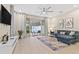 Open living room showcasing a sectional sofa, pool view, and modern decor at 17354 Blessing Dr, Clermont, FL 34714