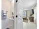 Small bathroom with pedestal sink and white cabinets at 1791 Yellow Trl, Lakeland, FL 33801