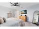 Main bedroom with ceiling fan, large dresser, and full-length mirror at 1791 Yellow Trl, Lakeland, FL 33801