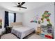 bedroom with a bed, bookshelf, and fun wall decor at 1791 Yellow Trl, Lakeland, FL 33801