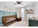 Bedroom with crib, rocker, and changing table at 1791 Yellow Trl, Lakeland, FL 33801