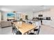Farmhouse dining table with black chairs and kitchen views at 1791 Yellow Trl, Lakeland, FL 33801