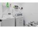 Bright laundry room with washer, dryer, and ample shelving at 1791 Yellow Trl, Lakeland, FL 33801