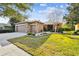 Single-story house with stone accents, a two-car garage, and a well-manicured lawn at 190 Verona Dr, Kissimmee, FL 34759