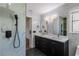 Modern bathroom with double vanity, marble tile, and walk-in shower at 2008 Dixie Belle Ave, Deltona, FL 32725