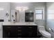 Modern bathroom with double vanity, marble tile, and walk-in shower at 2008 Dixie Belle Ave, Deltona, FL 32725