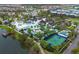 Aerial view of the community pool, clubhouse, lazy river, splash pad, basketball and tennis courts at 2186 Fleming Mist Pl, Kissimmee, FL 34747