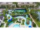 Aerial view of community lazy river, hot tub, pool, tennis and pickleball courts with mature landscaping at 2186 Fleming Mist Pl, Kissimmee, FL 34747