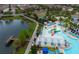 Aerial view of the community pool, splash pad, playground, dock, and lounging area at 2186 Fleming Mist Pl, Kissimmee, FL 34747