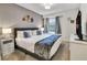 Inviting bedroom with a king bed, stylish décor, and a large window for natural light at 2186 Fleming Mist Pl, Kissimmee, FL 34747