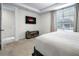 Bedroom featuring a king bed, stylish decor, and a flat-screen TV at 2186 Fleming Mist Pl, Kissimmee, FL 34747