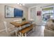 Cozy dining room featuring a rustic wooden table and bench seating, adjacent to an outdoor pool area at 2186 Fleming Mist Pl, Kissimmee, FL 34747