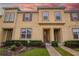 Inviting two-story townhome featuring a well-manicured lawn and a warm, inviting facade at 2186 Fleming Mist Pl, Kissimmee, FL 34747