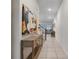 Bright foyer featuring tile flooring, decorative artwork, and an open view into the living area at 2186 Fleming Mist Pl, Kissimmee, FL 34747