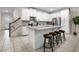 Stylish kitchen featuring white cabinets, a center island with bar seating, and stainless steel appliances at 2186 Fleming Mist Pl, Kissimmee, FL 34747