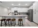 Modern kitchen featuring white cabinets, a center island with bar seating, and stainless steel appliances at 2186 Fleming Mist Pl, Kissimmee, FL 34747