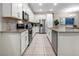 Modern kitchen featuring white cabinetry, stainless steel appliances, and tile flooring at 2186 Fleming Mist Pl, Kissimmee, FL 34747