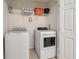 Convenient laundry room with modern washer and dryer, plus shelving for storage at 2186 Fleming Mist Pl, Kissimmee, FL 34747