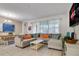 Inviting living room features a large sectional, dining area, and plenty of natural light at 2186 Fleming Mist Pl, Kissimmee, FL 34747