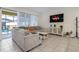 Comfortable living room with a large sectional sofa and sliding glass doors leading to an outdoor patio at 2186 Fleming Mist Pl, Kissimmee, FL 34747