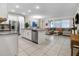 Open concept living room featuring tile floors, stainless appliances, and a large sectional sofa at 2186 Fleming Mist Pl, Kissimmee, FL 34747