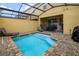 Tranquil pool features a screened-in lanai, brick patio, and lounge seating at 2186 Fleming Mist Pl, Kissimmee, FL 34747