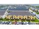 Beautiful townhome with yellow siding, brown shutters, and parking in front on a sunny day at 2186 Fleming Mist Pl, Kissimmee, FL 34747