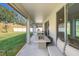 Covered patio with fire pit and seating area, overlooking a spacious backyard at 2230 Standing Rock Cir, Oakland, FL 34787