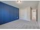 Bedroom with gray carpet and a blue accent wall at 2230 Standing Rock Cir, Oakland, FL 34787
