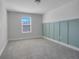 Bedroom with gray carpet, window, and teal accent wall at 2230 Standing Rock Cir, Oakland, FL 34787