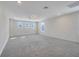 Large bonus room with gray carpet and multiple windows at 2230 Standing Rock Cir, Oakland, FL 34787