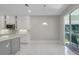 Bright kitchen with white cabinets, gray island, and view of the backyard at 2230 Standing Rock Cir, Oakland, FL 34787