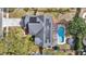 Aerial view of home, highlighting backyard pool, shaded pergola, trampoline, solar panels and landscaping at 2417 Liela Lee Ct, Ocoee, FL 34761