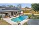 Aerial view of the backyard with a pool, patio, solar panels and grass at 2417 Liela Lee Ct, Ocoee, FL 34761